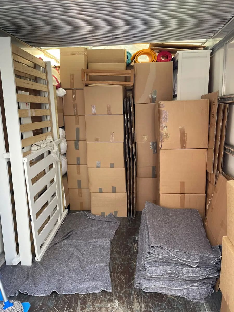 Packed boxes and protected furniture loaded in a removals van
